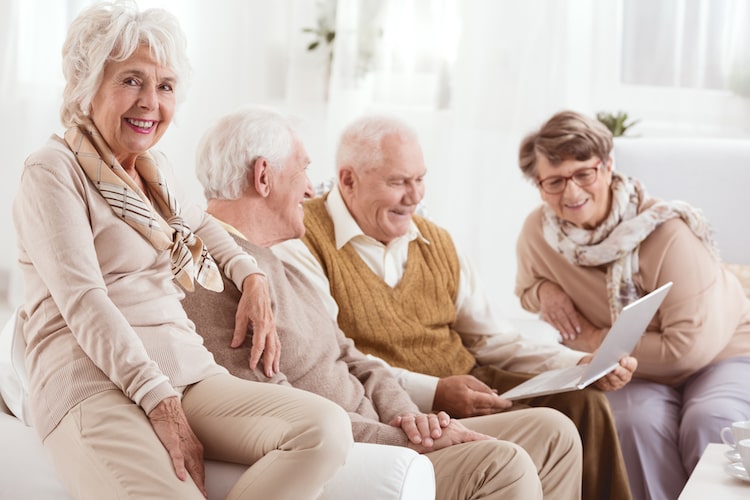 Group of seniors discussing the value of a continuing care retirement community