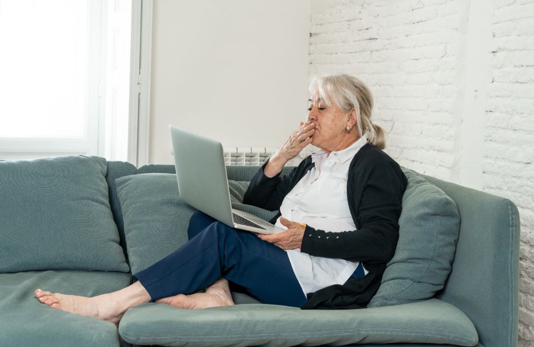 Senior woman finding safe ways to stay socially active through video chatting.