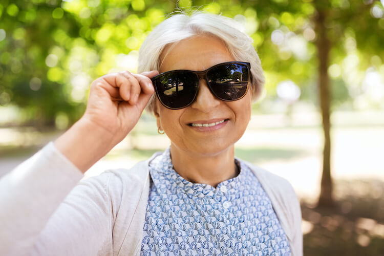 Senior woman caring for her eyes by wearing sunglasses.