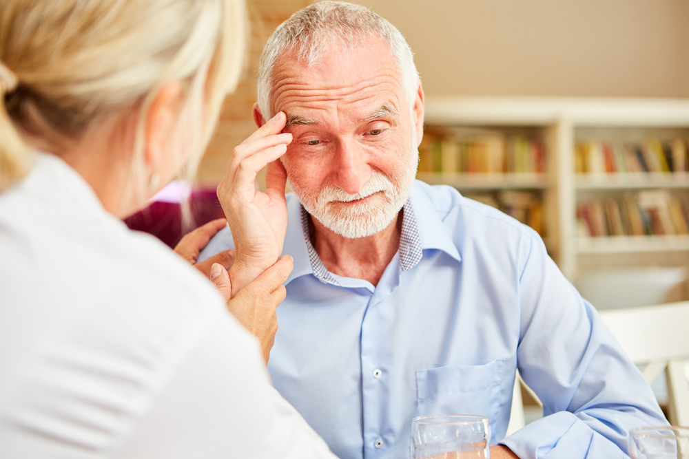 A senior man with a headache