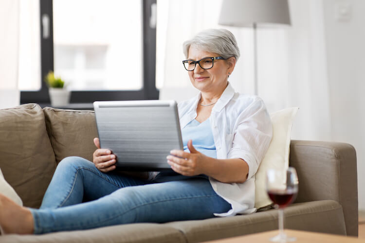 Happy senior woman researching on her computer.