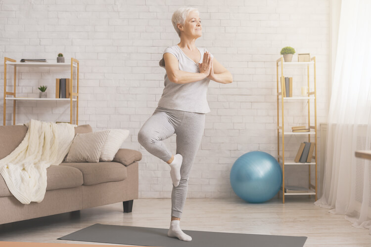 Senior woman doing yoga to help increase balance.