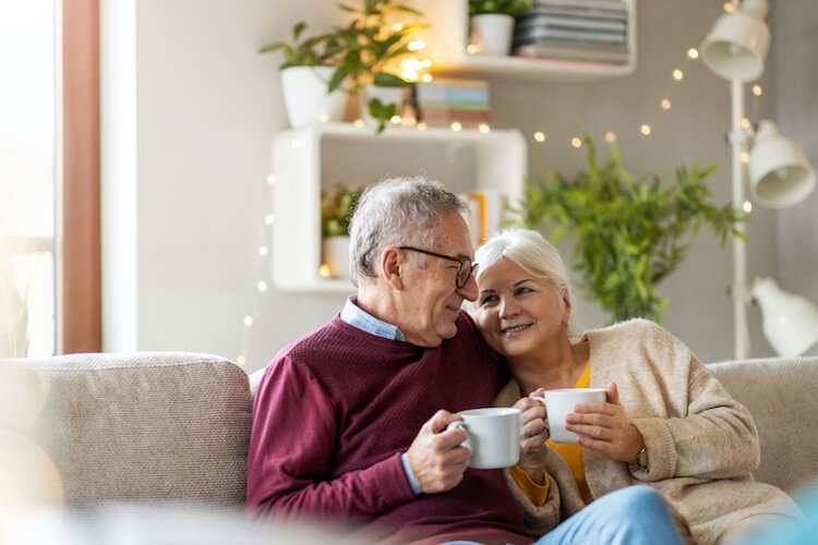 Happy senior couple feeling safe and secure in their home.