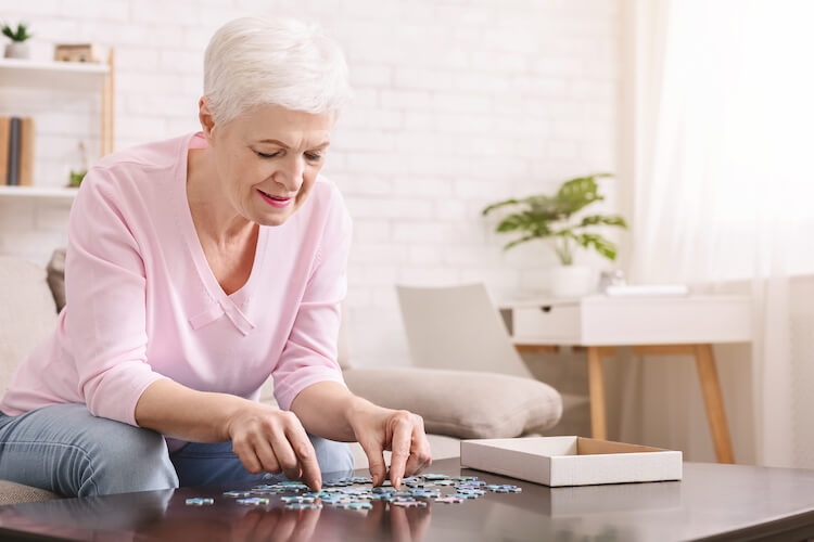 Senior woman working on a puzzle.