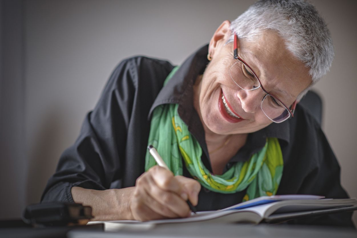 Senior woman making a list of her New Year’s resolutions.