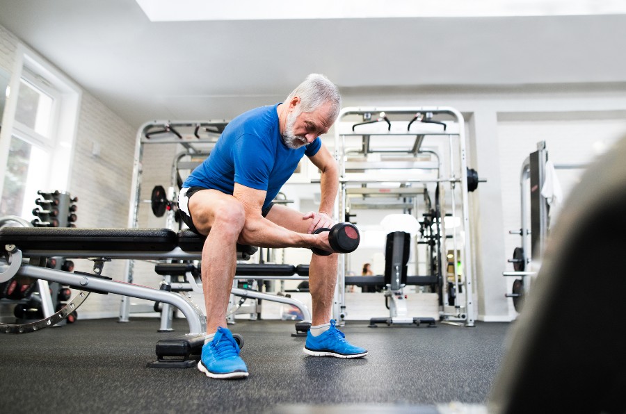 Senior man lifting weights