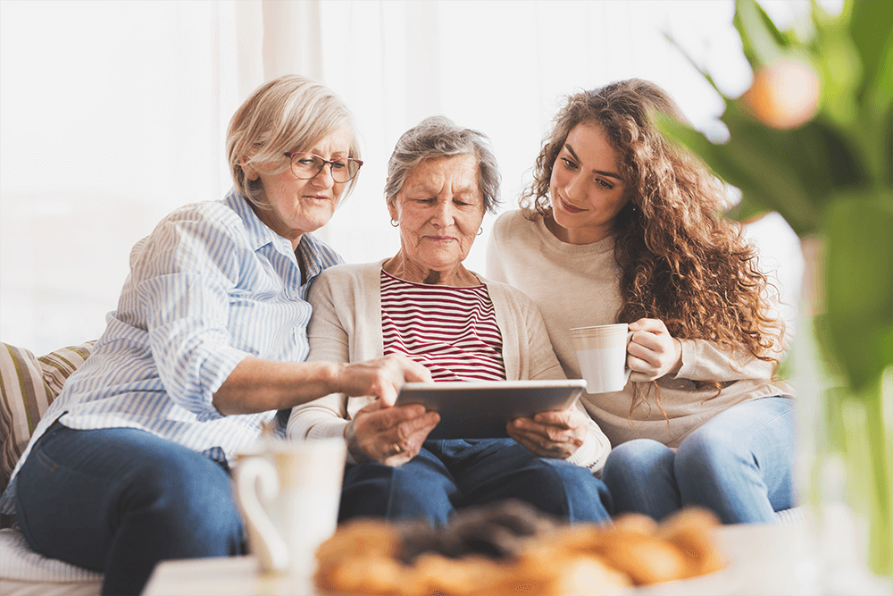 A family of multiple generations looking at photo album