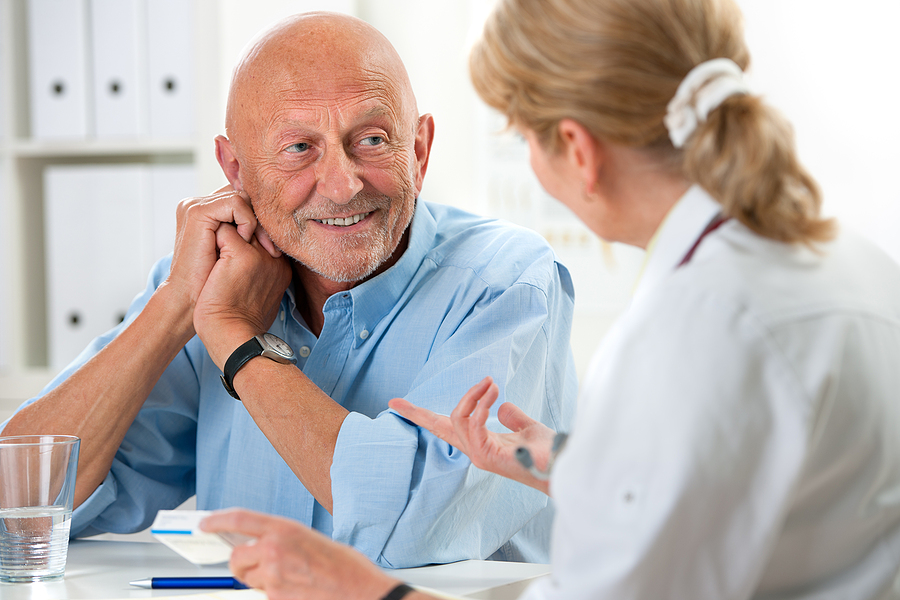 A doctor talks with an older man.