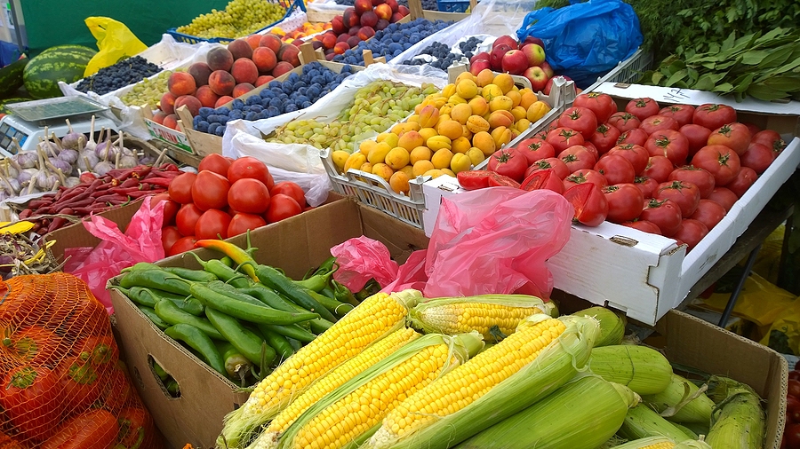 A farmers market bursts with fresh produce.