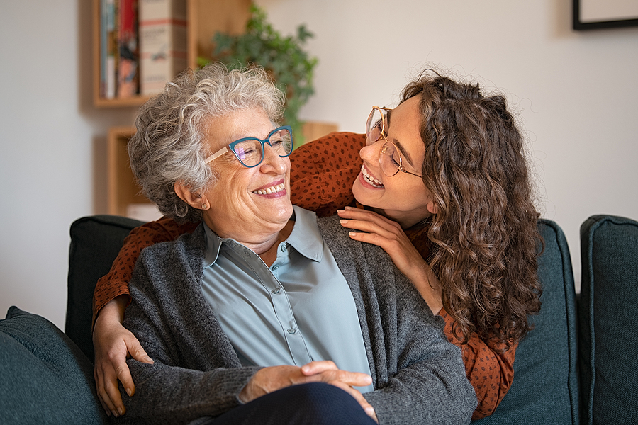 Elderly mother laughing with her daughter