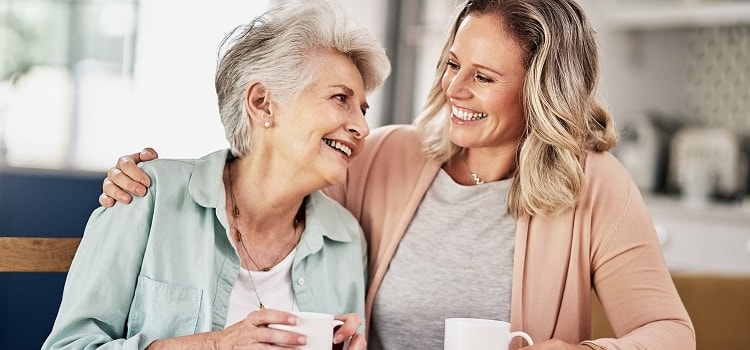 senior woman and daughter smiling