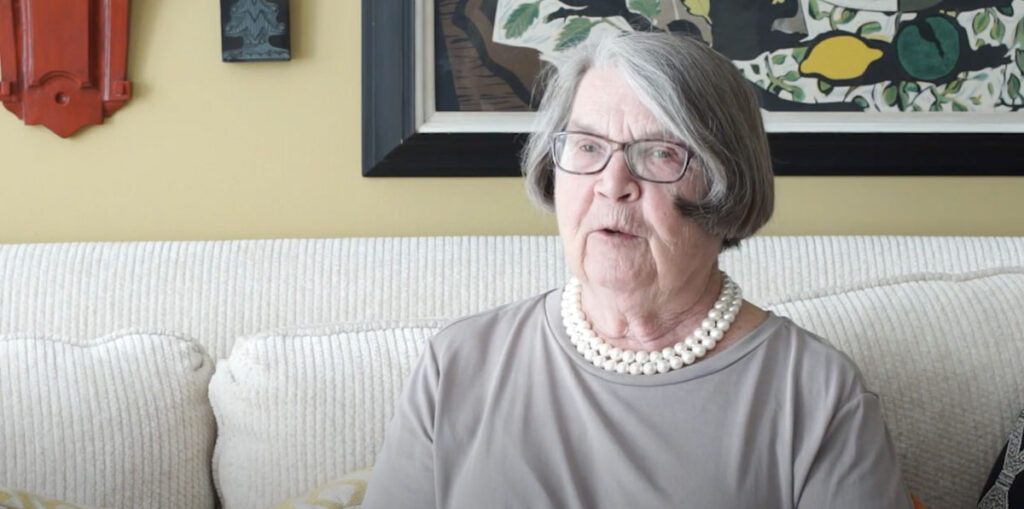 senior woman in grey with pearls