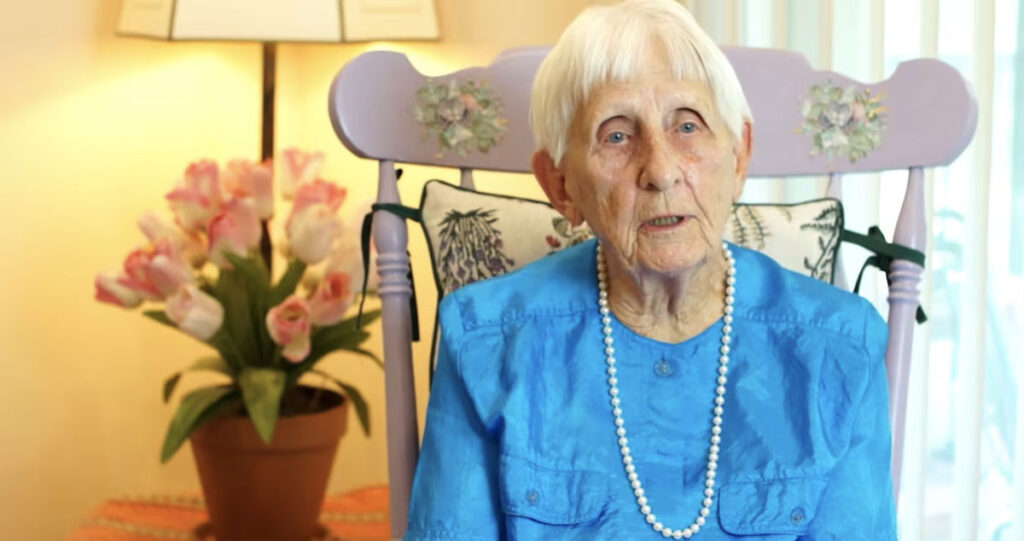 Senior woman in blue with pearl necklace