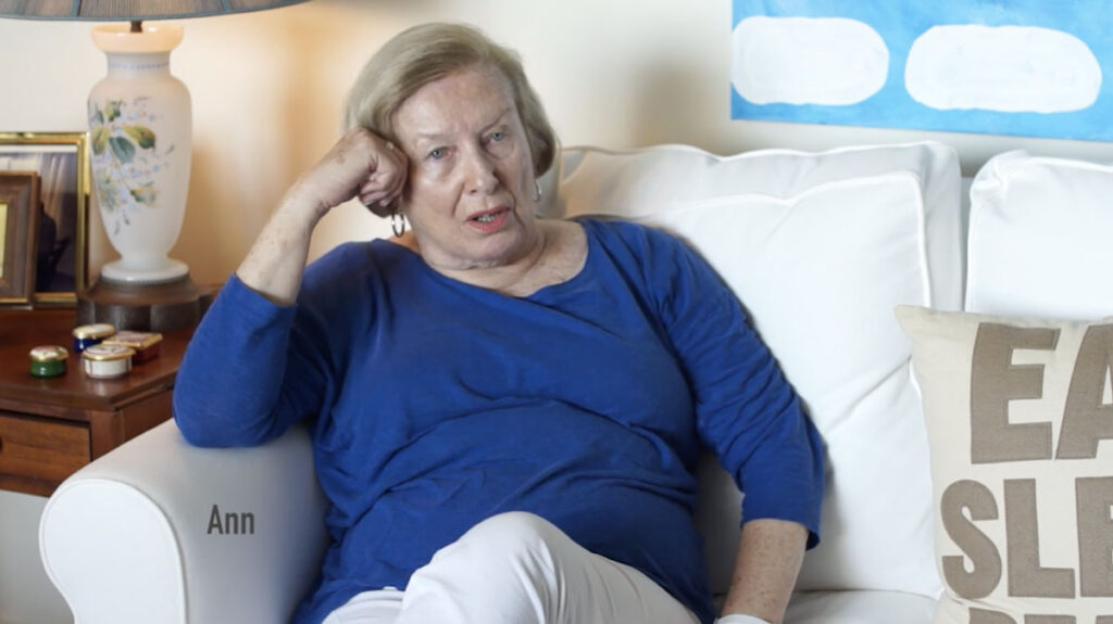 Senior woman in blue sweater on couch