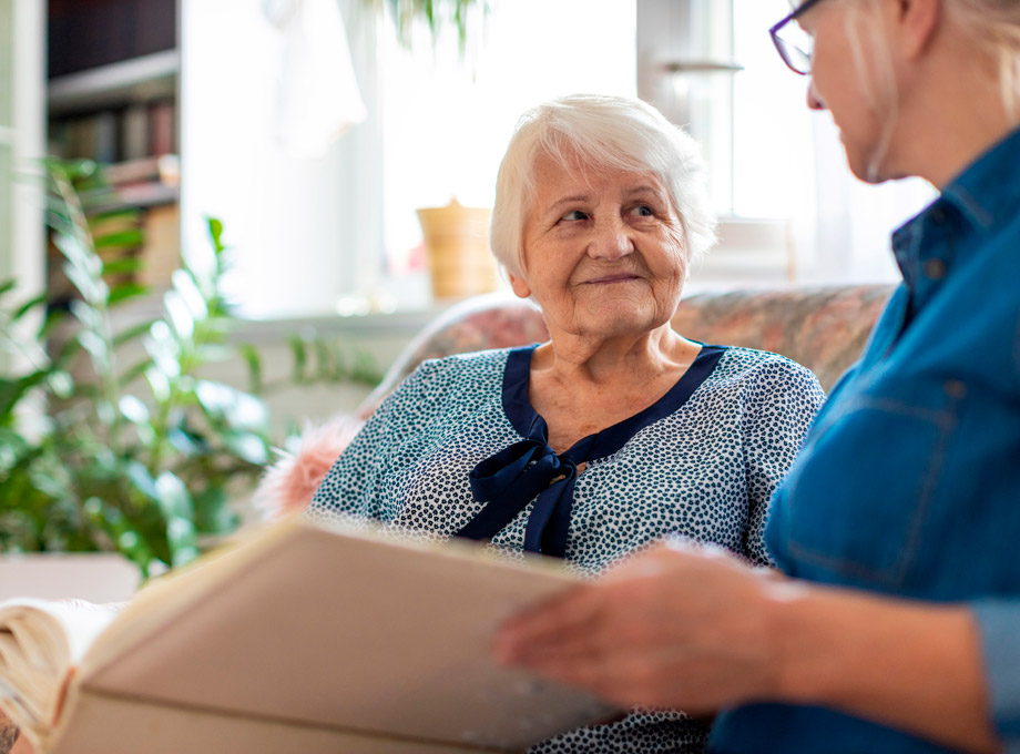 Senior woman looking at aid with book