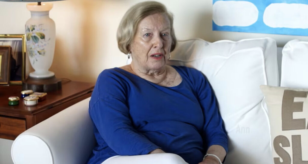 senior woman in blue sweater on couch