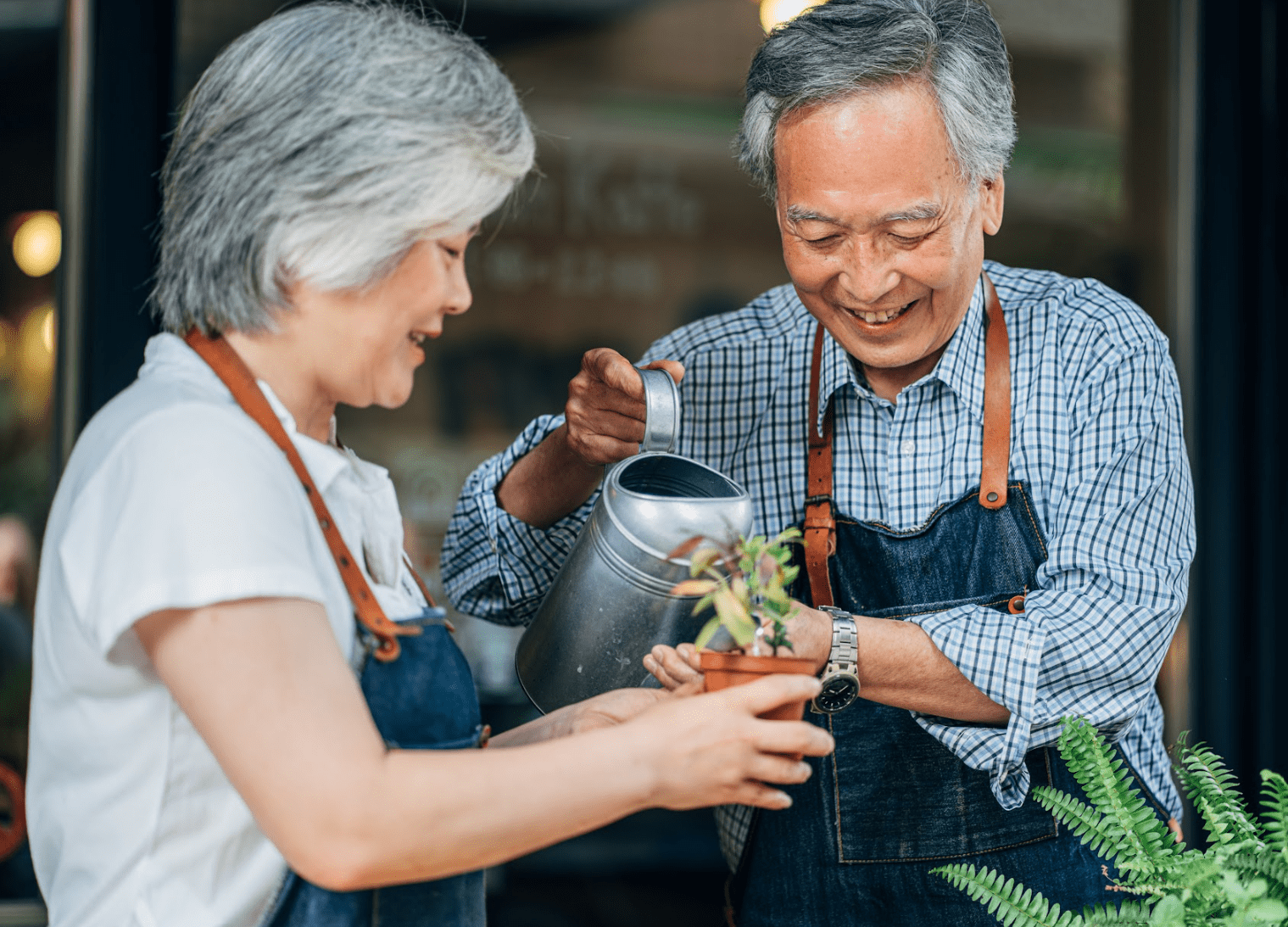 seniors watering plant-min