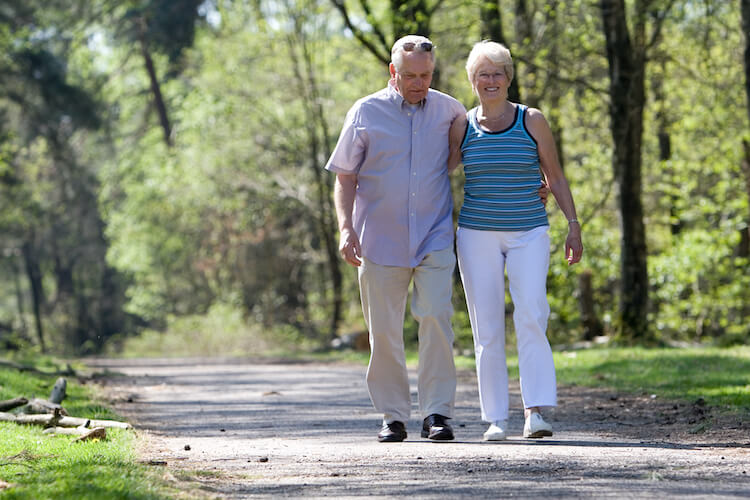 Senior couple taking a walk outdoors.