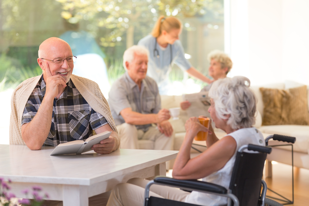 Seniors in assisted living meeting in a common area