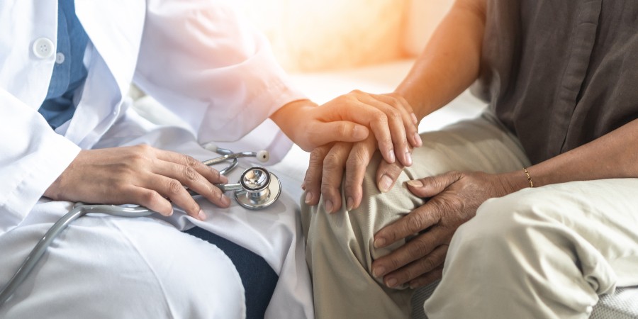 Geriatric doctor consulting with a Parkinson's disease patient