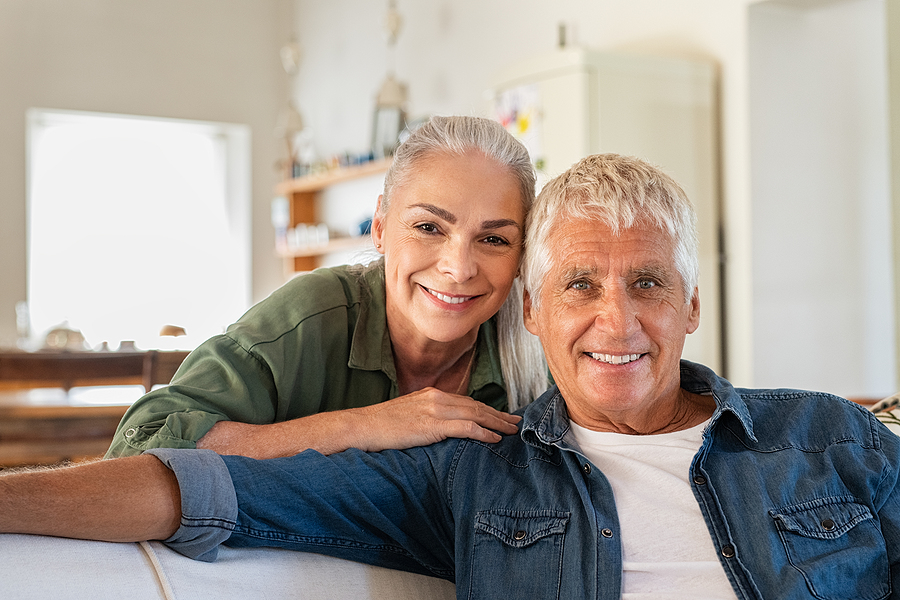 Couple smiling together on a couch