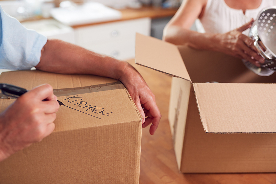 Senior packing moving boxes