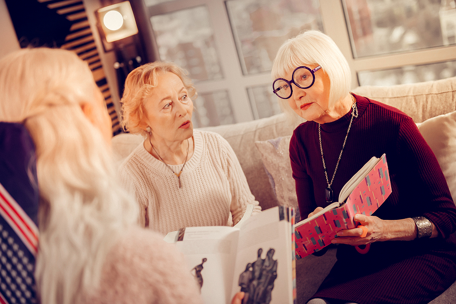 Seniors Book Club Older women gathered for a book club meeting