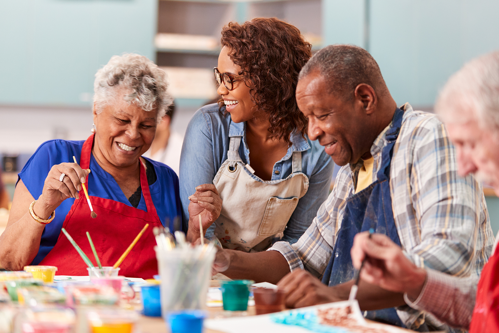 A group of older adults in a senior living community participate in an art class Senior Living Community Life