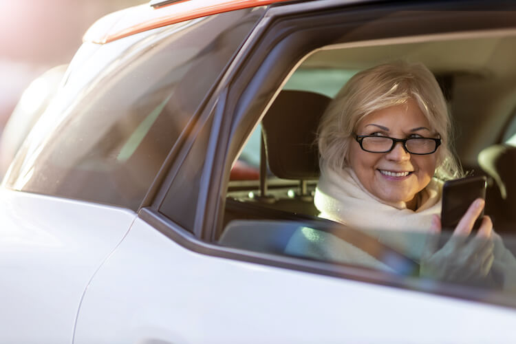Senior woman in a ridesharing car.