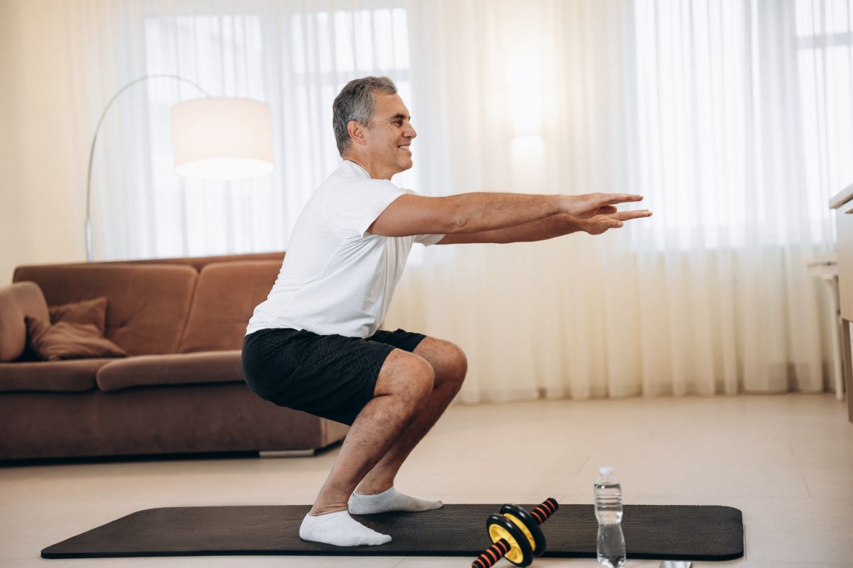 Senior man performing physical exercise from the comfort of his home.
